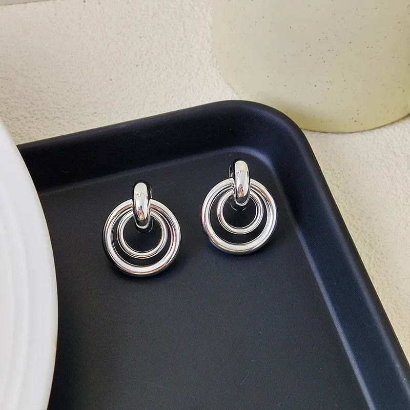 Geometric round ring earrings with irregular design in gold and silver electroplated finishes