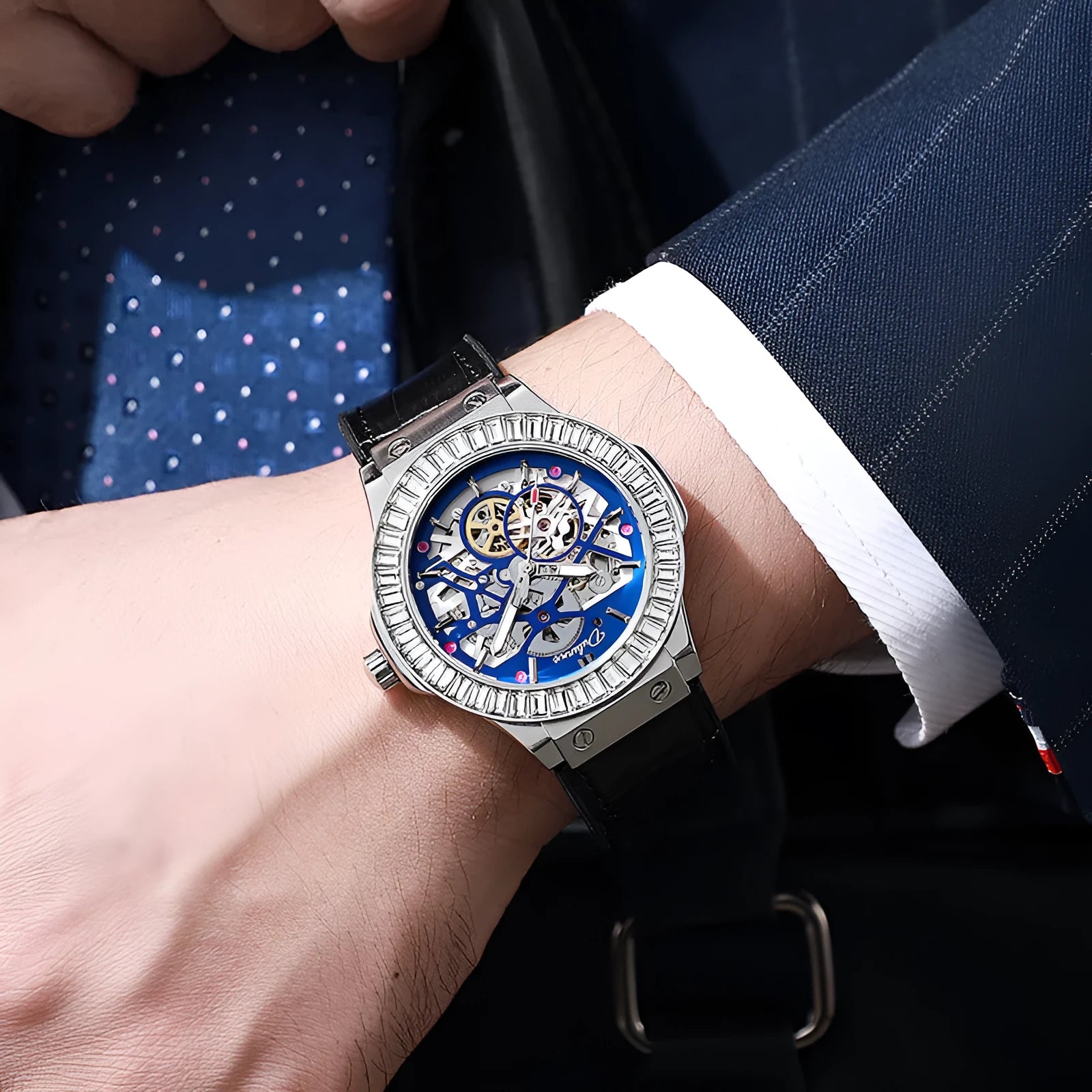 Automatic diamond studded skeleton men's watch with white shell case and blue dial on leather strap.