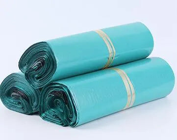 A bundle of 100 flat, clear PE plastic courier bags for clothing with adhesive sticker seals.