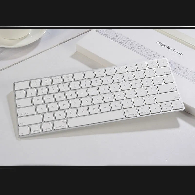 Genuine white Apple Bluetooth G6 wireless keyboard with ultra-thin metal build on a desk.