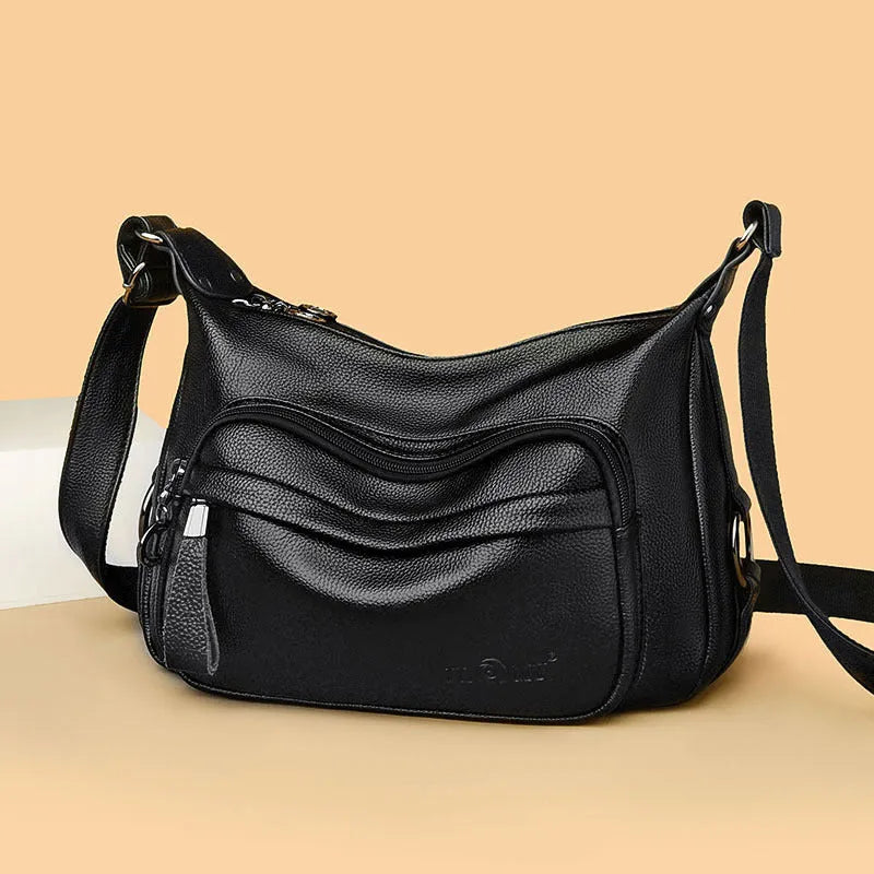 Large blue PU crossbody shoulder bag with multiple internal compartments and luggage-style design