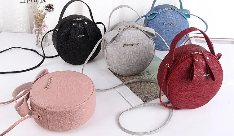 Women's round PU leather crossbody bag in circular shape, 17cm wide, with separate pouch