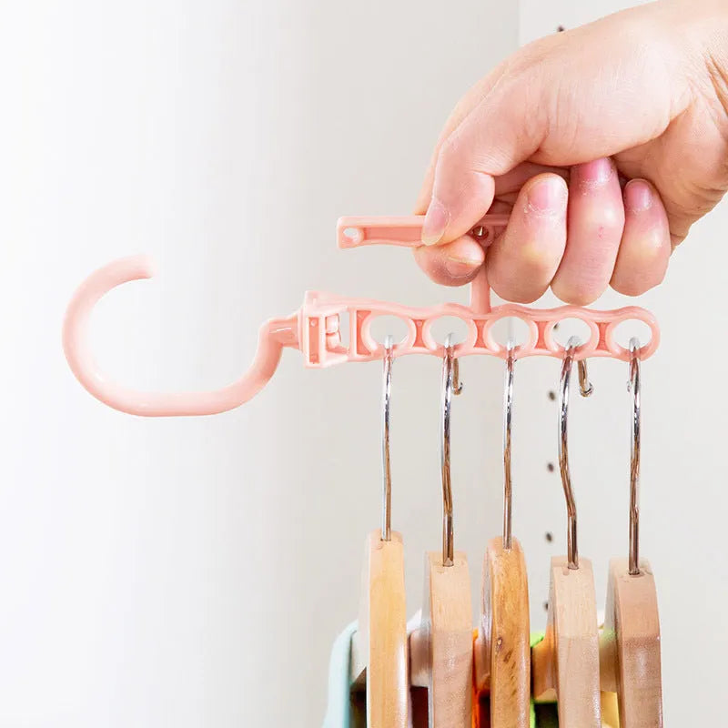 Blue revolving wardrobe hanger with five rotating branches and a central carry handle.