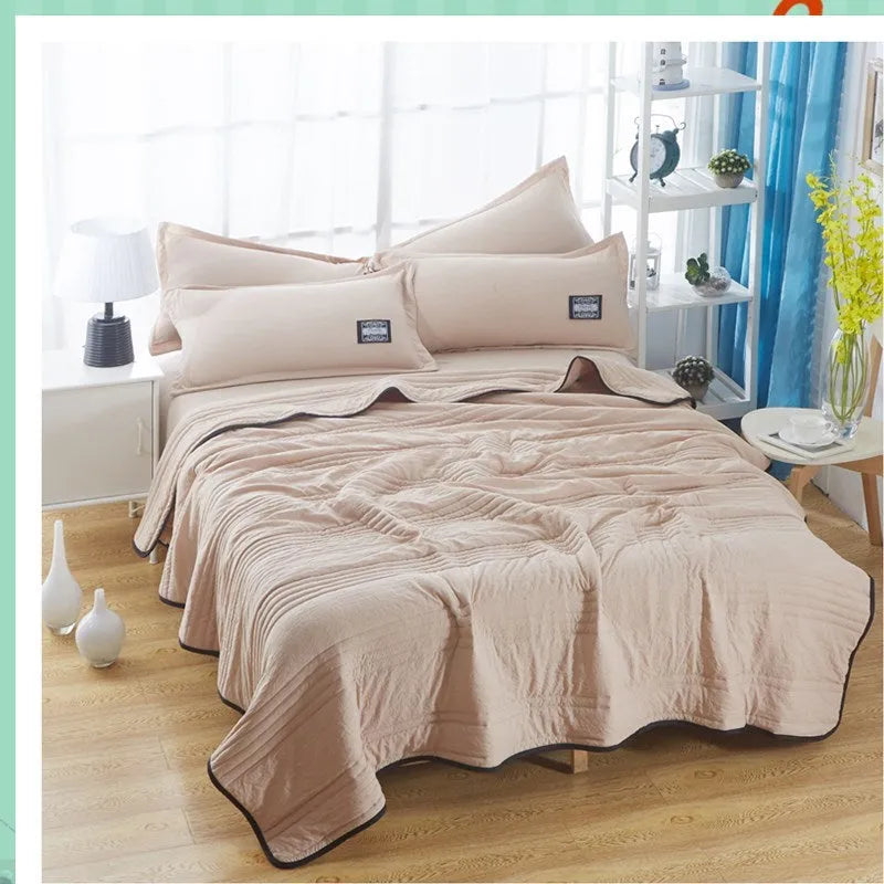 Pure colour seersucker cooling air-conditioning quilt laid flat on a bed
