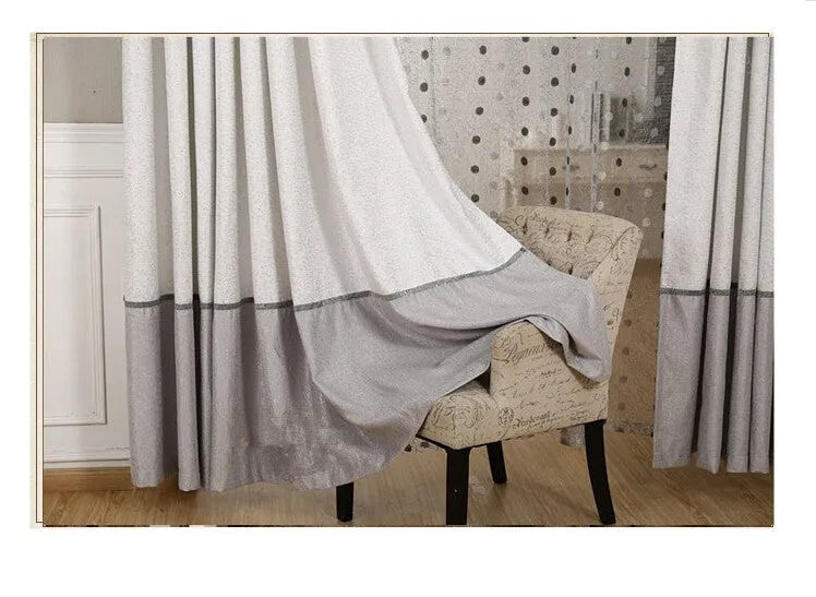 Single black blackout curtain panel with hook heading, shown hung on a pole.