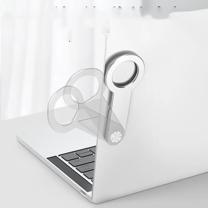 Metallic silver aluminium alloy magnetic phone holder for iPhone on a desk.
