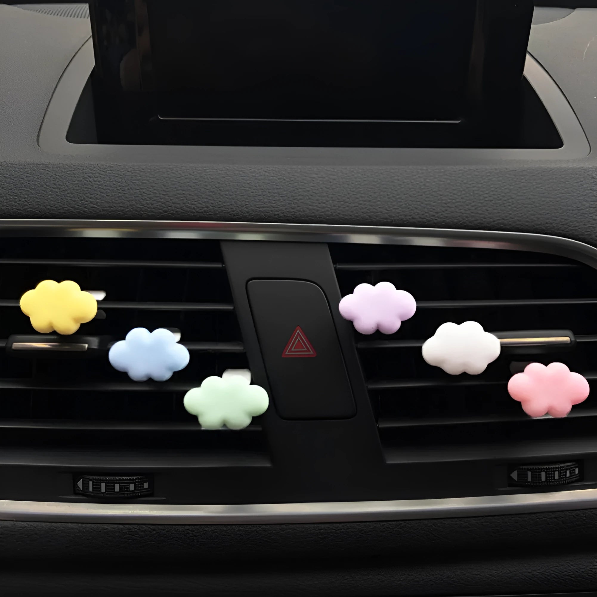 Resin cartoon cloud car fragrance clip in pastel colours mounted on vehicle air vent