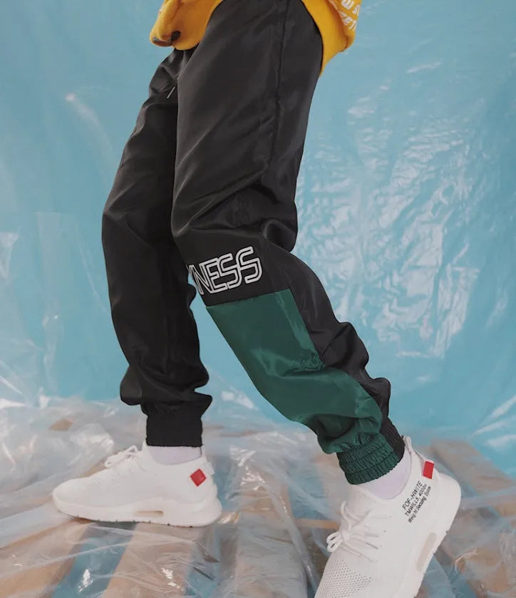 Japanese hip hop trousers with hit colour stitching, letter print, and bouquet foot detail in green low-waist drawstring style