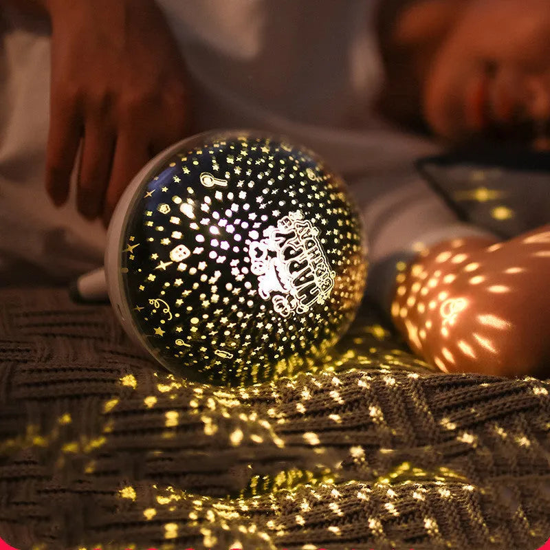 Black and white rotating cartoon starlight projection lamp on a table.