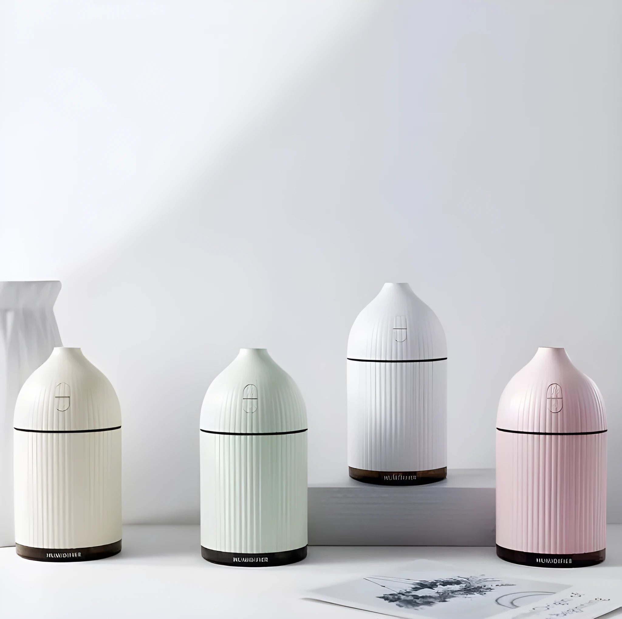 White ultrasonic aromatherapy diffuser with LED light, 300ml water tank, and USB cable.