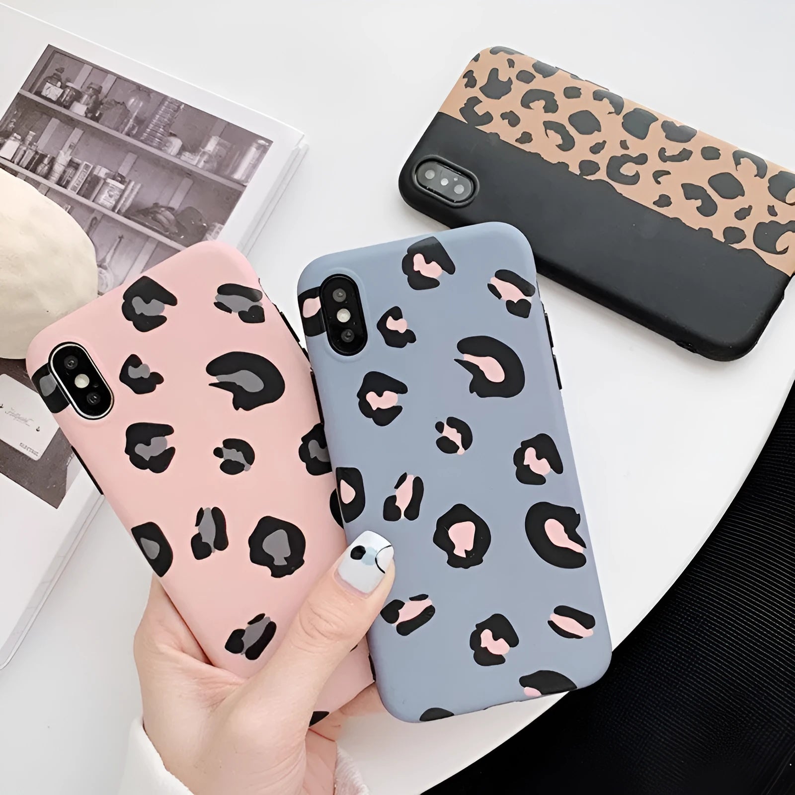 Leopard print iPhone case in black, blue, and pink colours for multiple iPhone models.