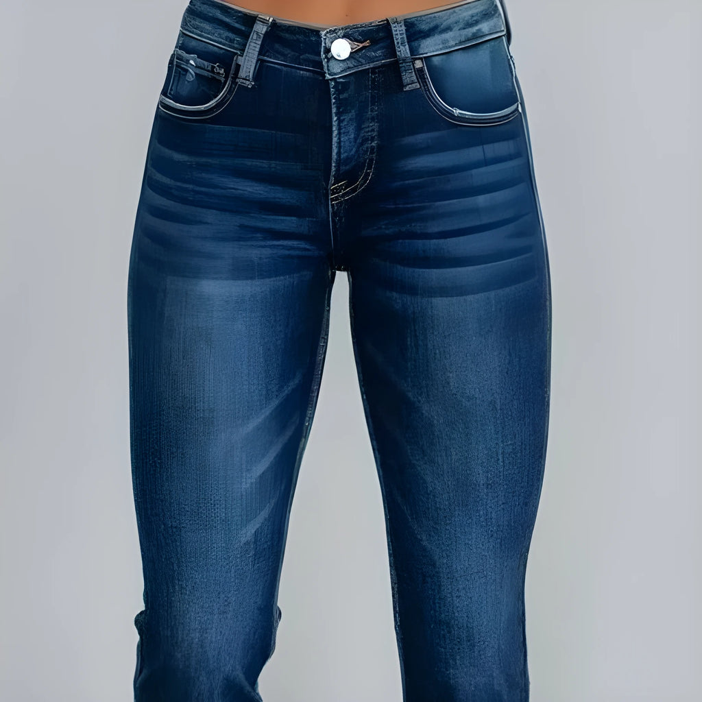 Women's dark blue cotton denim jeans with hand-worn distressing detail on the front.