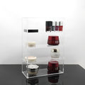 Clear acrylic cosmetics storage box 24x10x34cm on a vanity table holding makeup and skincare products