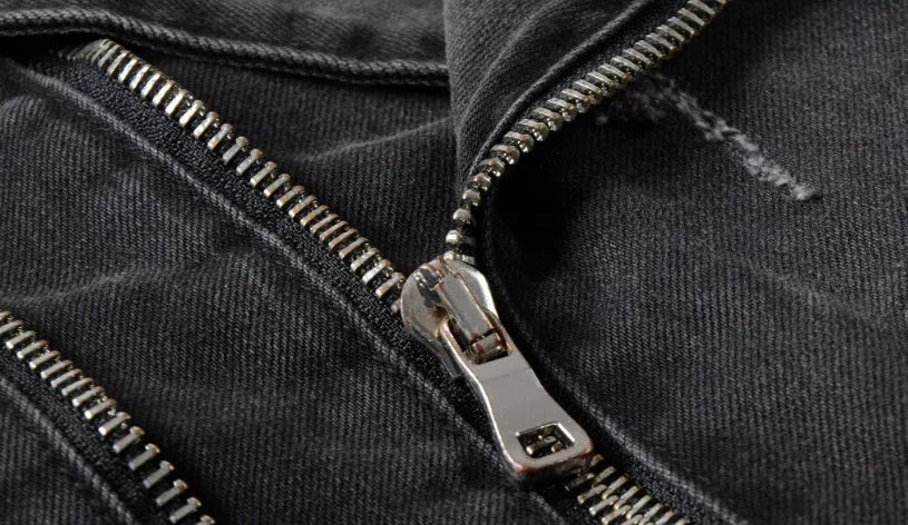 Black slim fit linen denim jacket with zipper front, zipper pockets, and lapel collar on a person