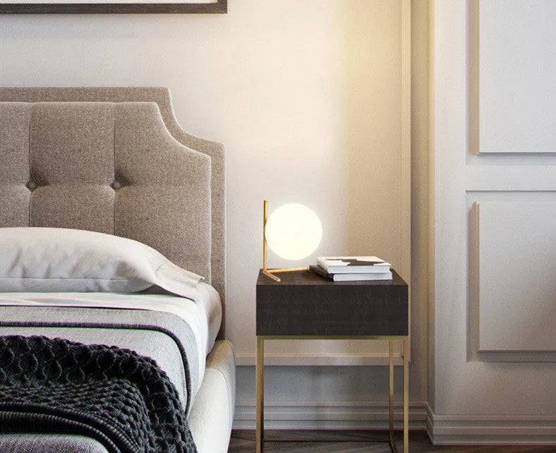 Creative glass desk lamp with three-tone LED lighting on a wooden desk.