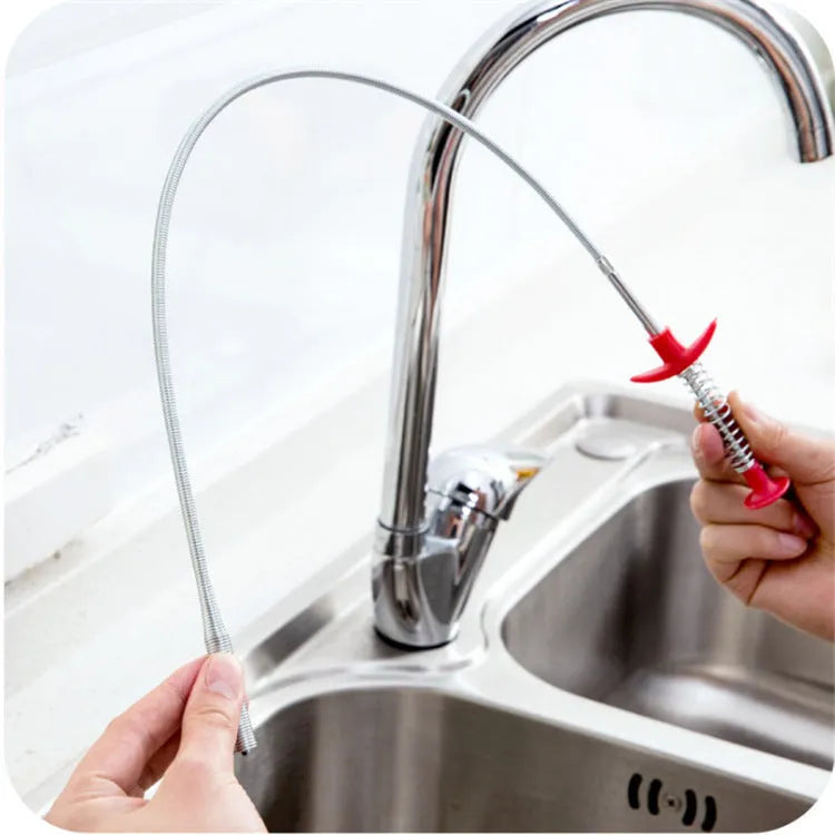 Black flexible sewer dredger spring drain cleaning tool with a textured grip on a white background.