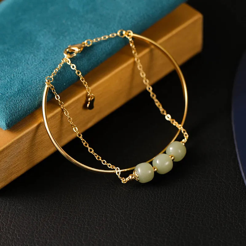 Women's Hetian jade lucky bracelet with gold inlay in single, double, and three bead styles.