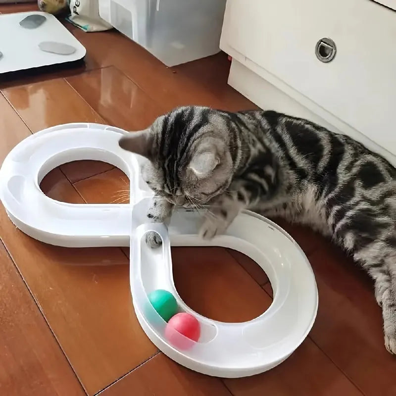 Blue and white plastic cat turntable track toy with balls and a feather teaser wand.