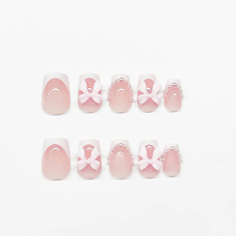 Short white French manicure press-on nails with bow, tulip, and starry sky decorative patterns