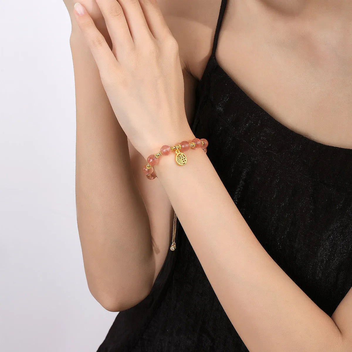 Women's strawberry quartz crystal bracelet with geometric design and fu character element