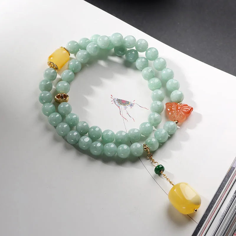 Close-up of a double-layer women's bracelet with green jade round beads and brown beeswax barrel beads in a geometric design.