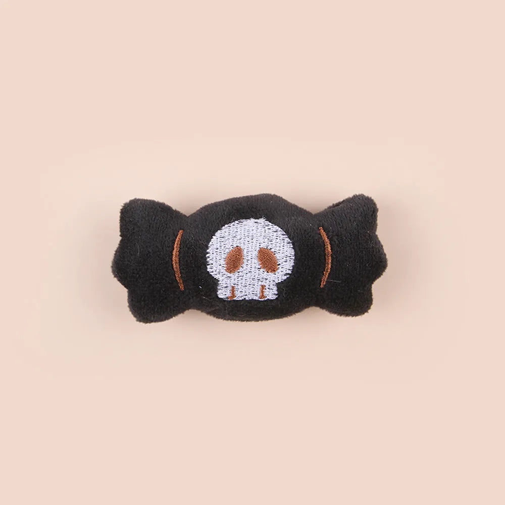 Small plush cat teaser toy with candy, eyes or skull design and feather attachment