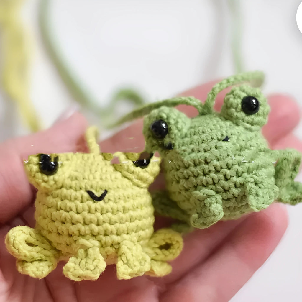 Handmade woven car pendant with small green frog design measuring 15cm long