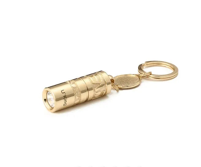 Gold zinc alloy waterproof LED keychain torch for outdoor and emergency use.