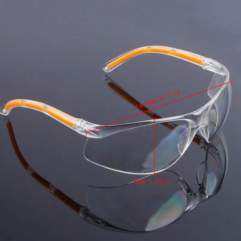 Transparent safety goggles with yellow tinted polycarbonate lenses for lab and welding protection.