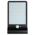 Black and white outdoor solar-powered garden light with LED illumination for pathways.