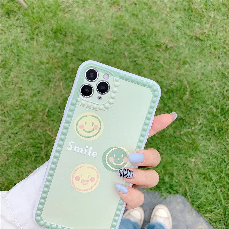 Green iPhone case with smiley face and polka dot geometric design on a soft rubber TPU back cover.