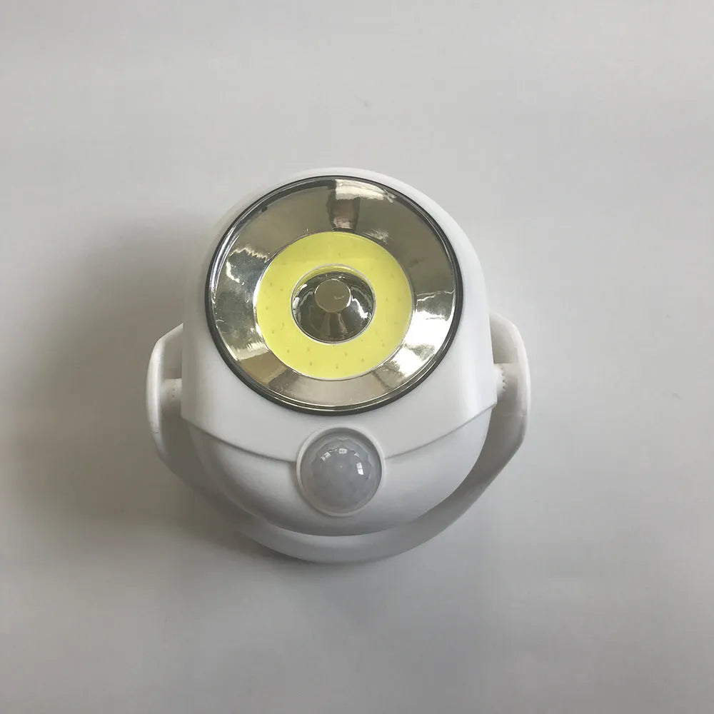 White Atomic Angel shaped induction night light on a surface.