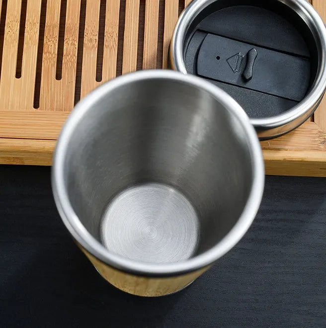 Bamboo and stainless steel insulated coffee cup with lid and foam pad, 420ml capacity.