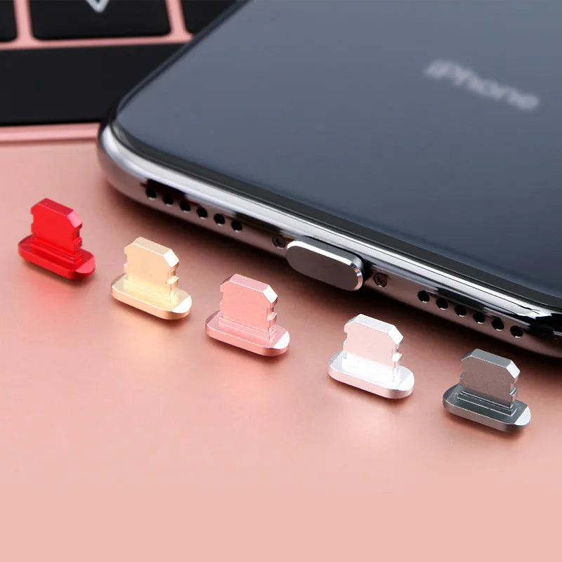 Aluminium alloy iPhone charging port dust plug in gold, silver, blue, red, grey, black, and rose gold colours.