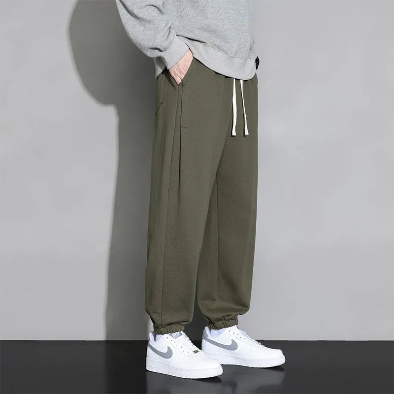 Men's loose fit grey cotton sports trousers with elastic waistband and drawstring closure
