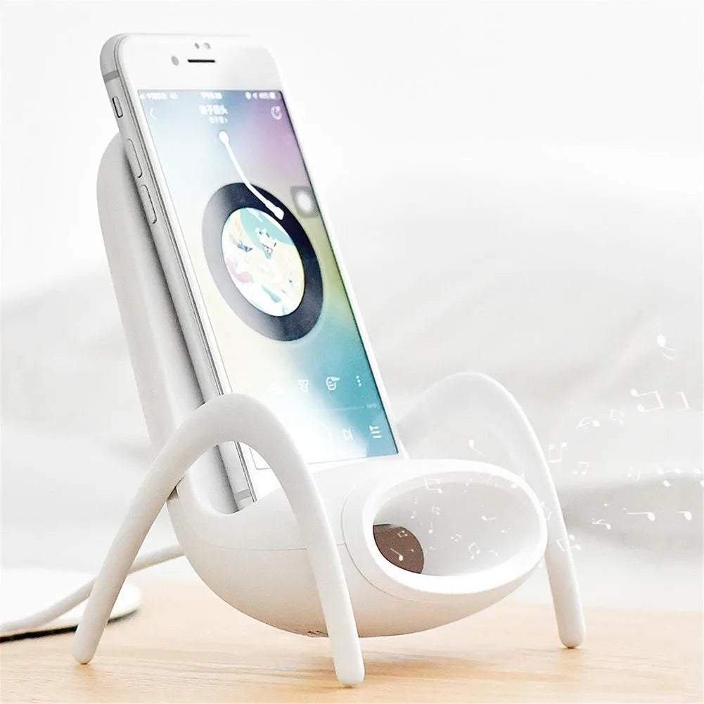 White wireless charging phone stand on a desk, charging a mobile phone at a viewing angle.