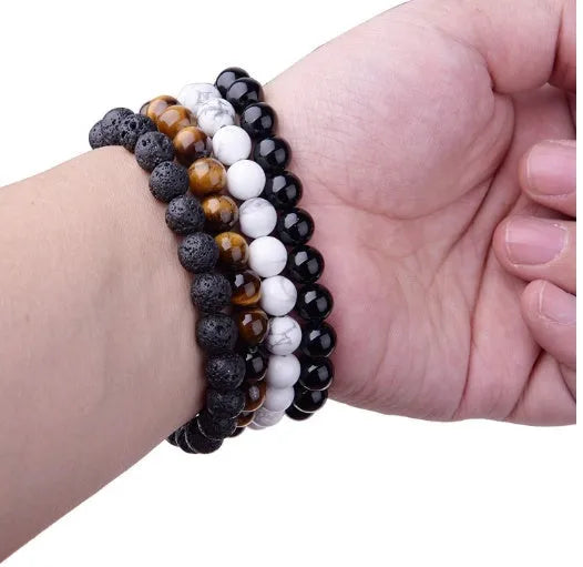 Geometric black agate bead bracelet with elastic cord, showing 8mm bead size detail.