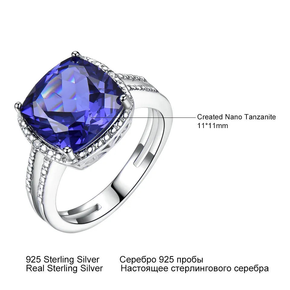 Blue tanzanite stone set in a sterling silver women's ring on a white background.