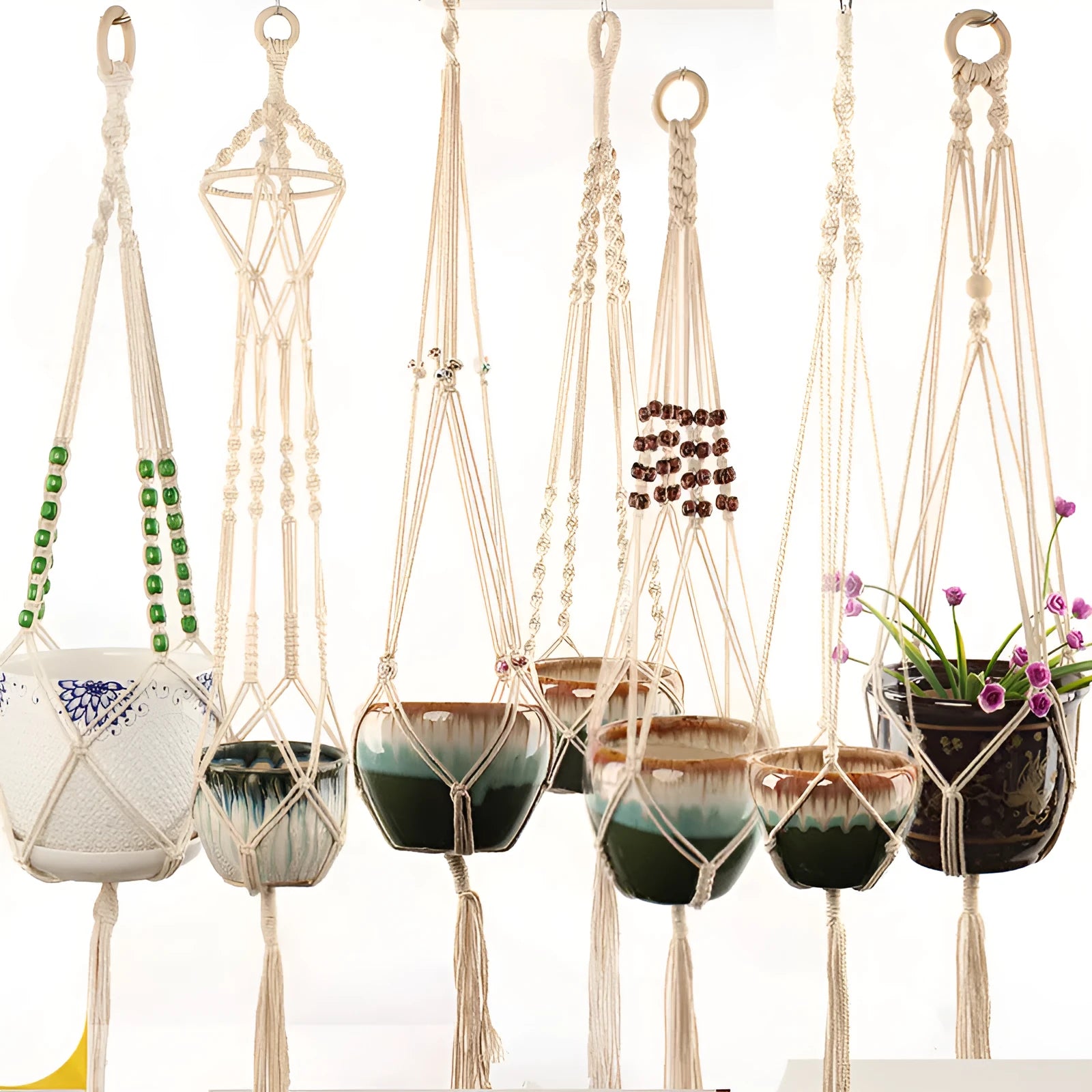 Woven wire planter basket made from cotton rope, shown in a desktop style holding a small plant.