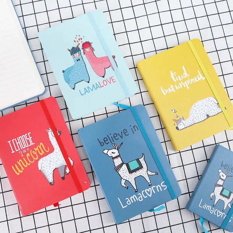 Alpaca cartoon design notepad open showing yellow paper, available in A5, A6, and A7 sizes.