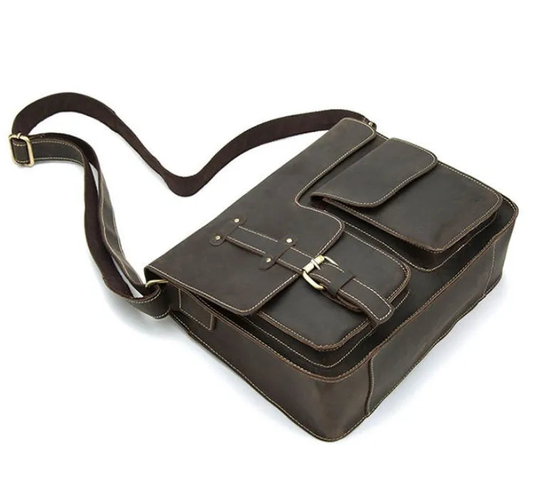 Brown leather vintage messenger bag with a flap closure and adjustable crossbody strap.