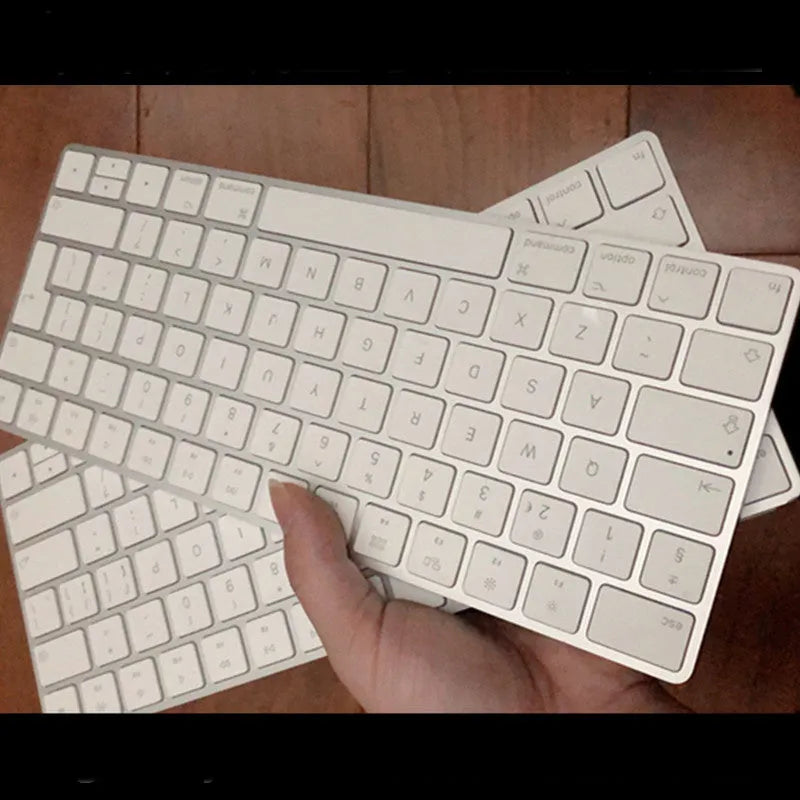 Genuine white Apple Bluetooth G6 wireless keyboard with ultra-thin metal build on a desk.