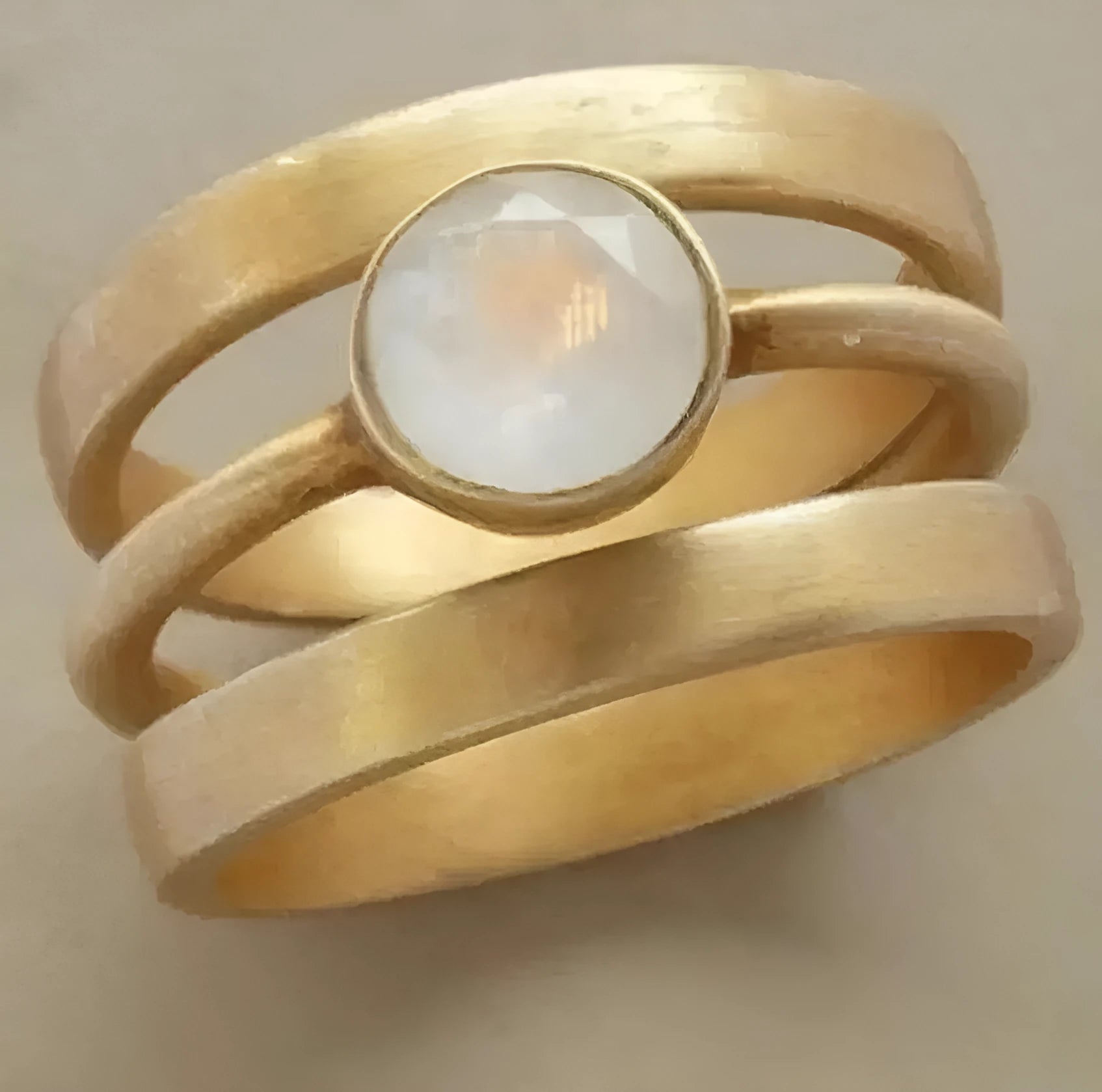 Gold-plated hollow geometric titanium steel ring with micro-inlaid white chalcedony stone detailing.
