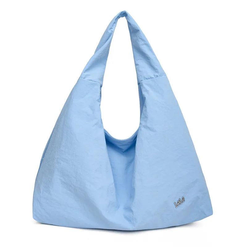 Soft nylon women's underarm bag in heart shape, shown in black, yellow, khaki, or blue.