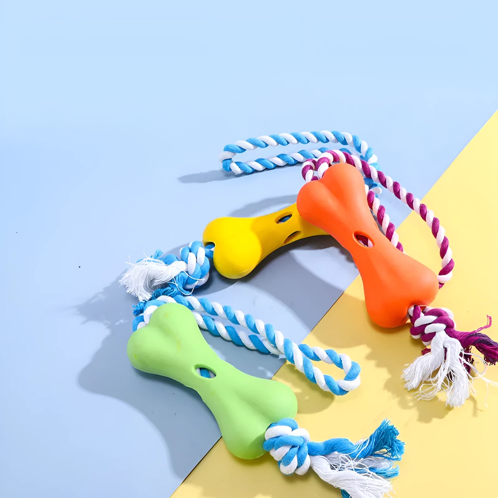 Green porous bone-shaped rope dog toy with knotted texture for chewing and treat hiding