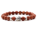Tigereye and natural stone stretch bracelet with 8mm beads on a wrist.