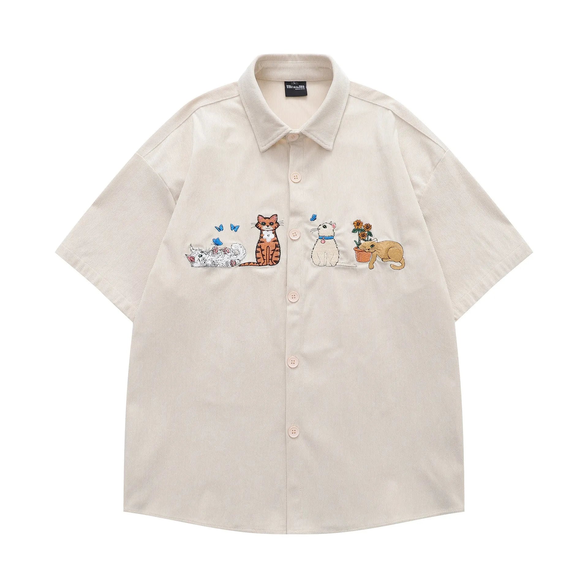 Loose apricot cardigan shirt with cartoon embroidery pattern on a hanger.