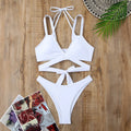Women's solid colour bikini swimsuit with adjustable straps on a hanger, shown in red.