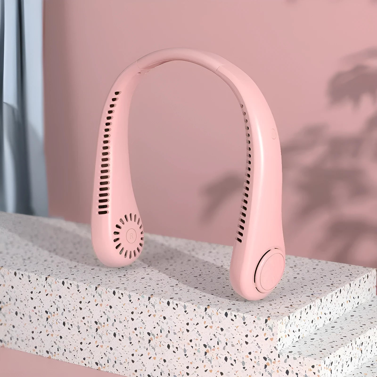 Pink USB charging portable bladeless neck fan worn around neck with adjustable speed settings