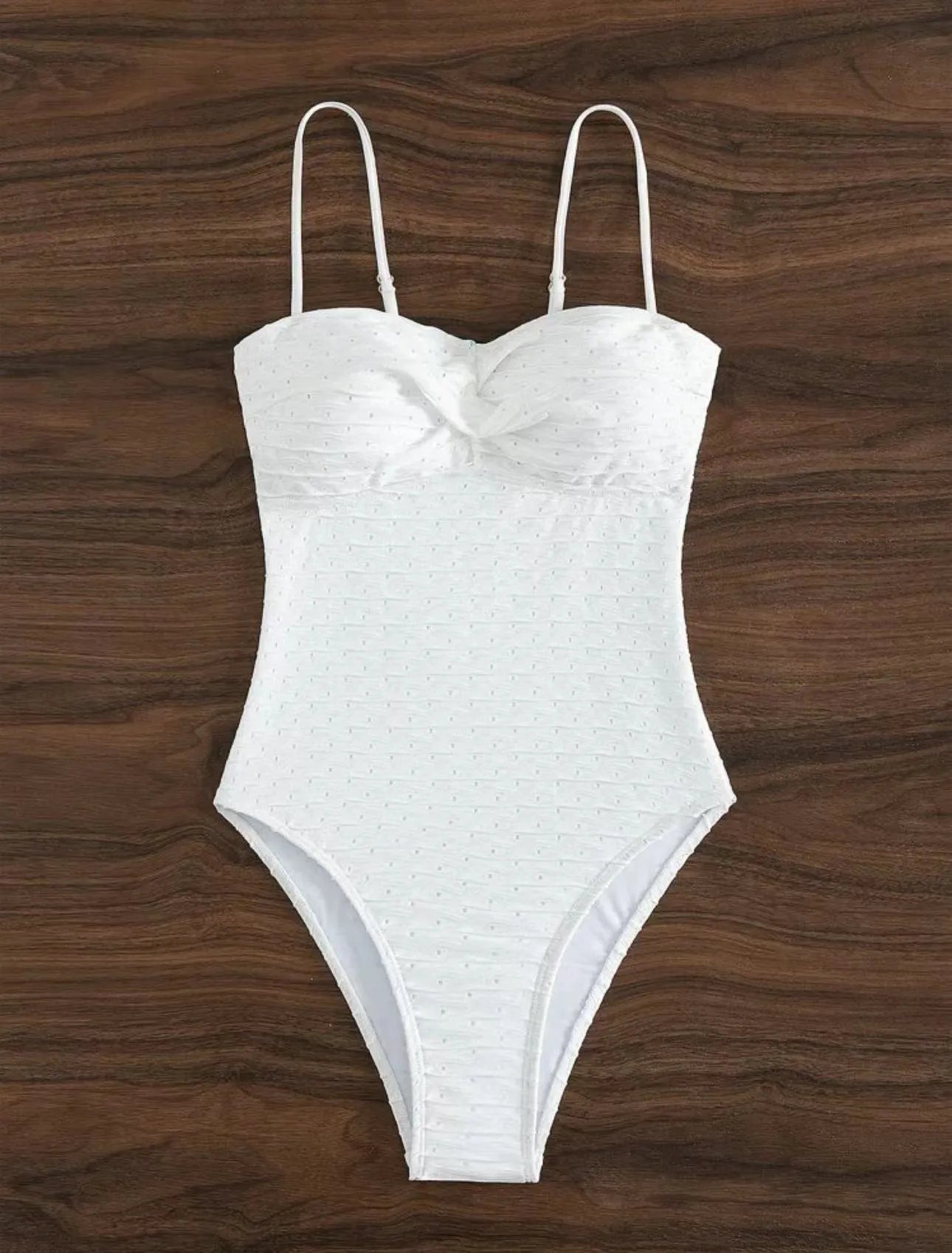White women's one-piece swimsuit with a sling back design on a mannequin.